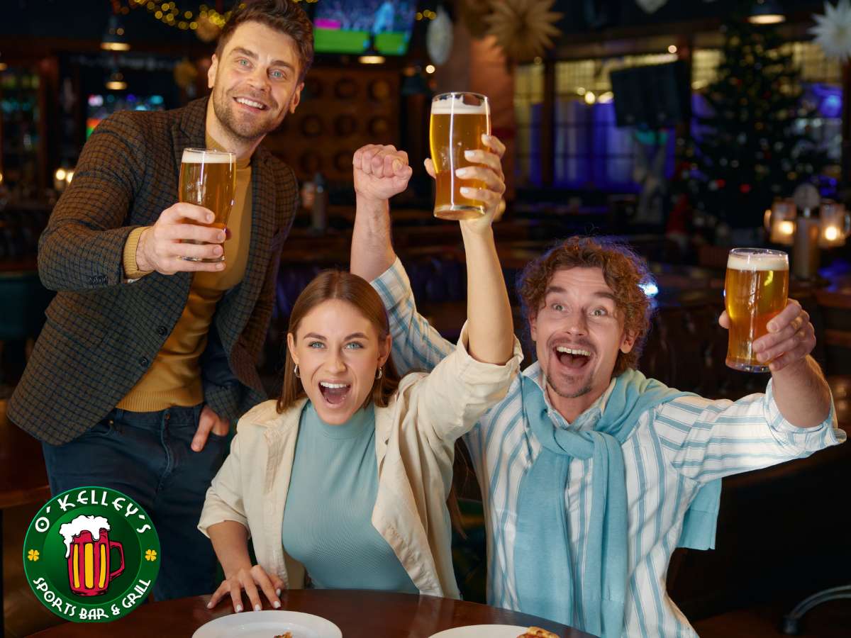 Group of friends enjoying Happy Hour in a sports bar with beers raised in celebration at O'Kelley's Sports Bar & Grill.